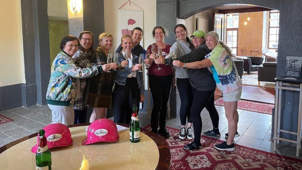 AWROA_Boot_Camp_Team_picture_October23_gradient_1500x844 Group picture of AWROA organizers, mentors and speakers toasting at Schloss Mutzschen with picture overlay